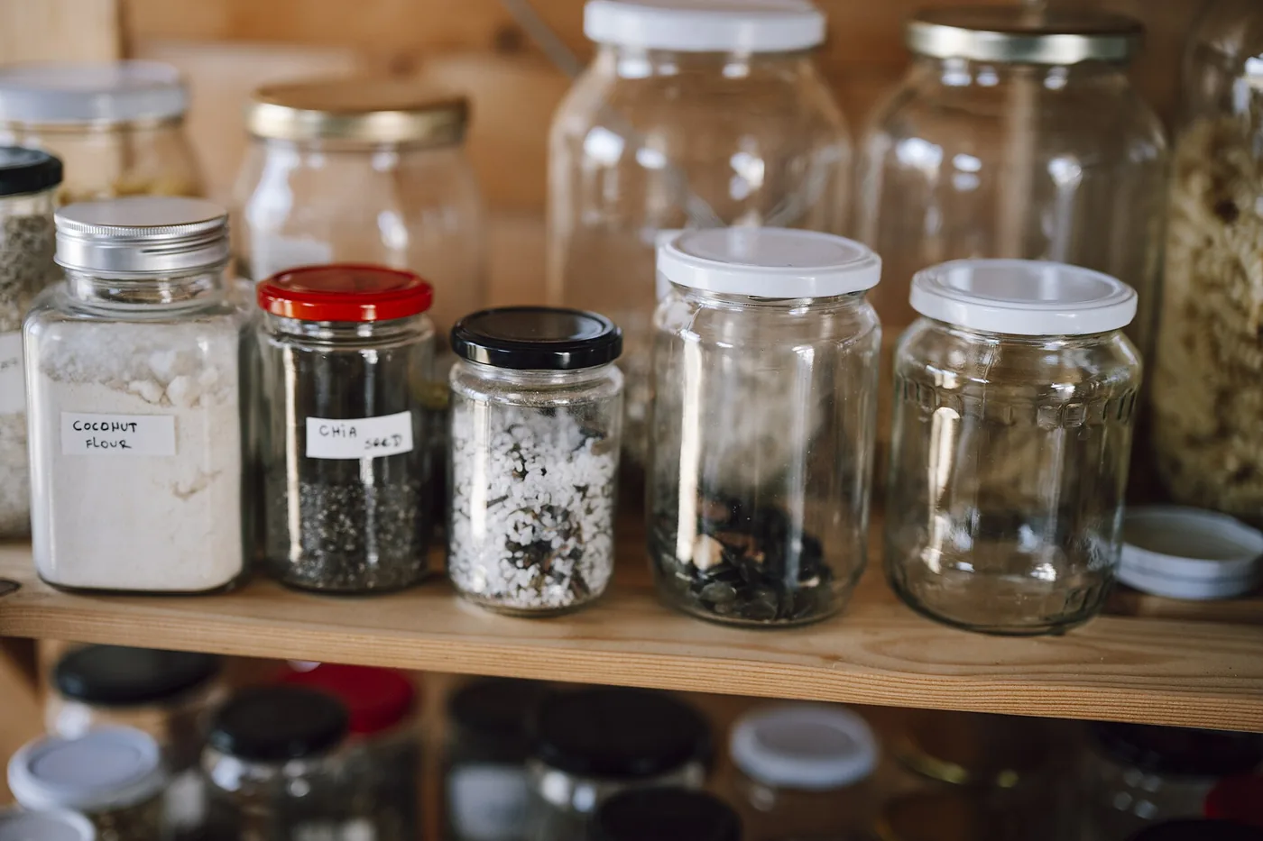 Tarros y envases alineados en una despensa doméstica